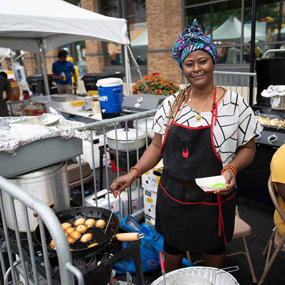 a person making food at a festival