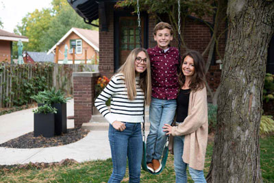 boy on a swing posing with family members