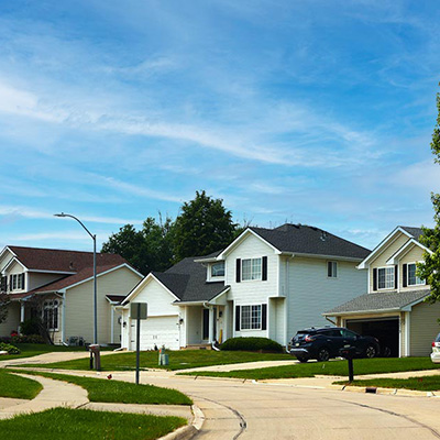 Two story homes up a hill.