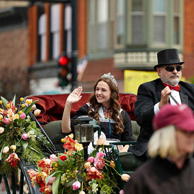 image of an individual waving in a parade