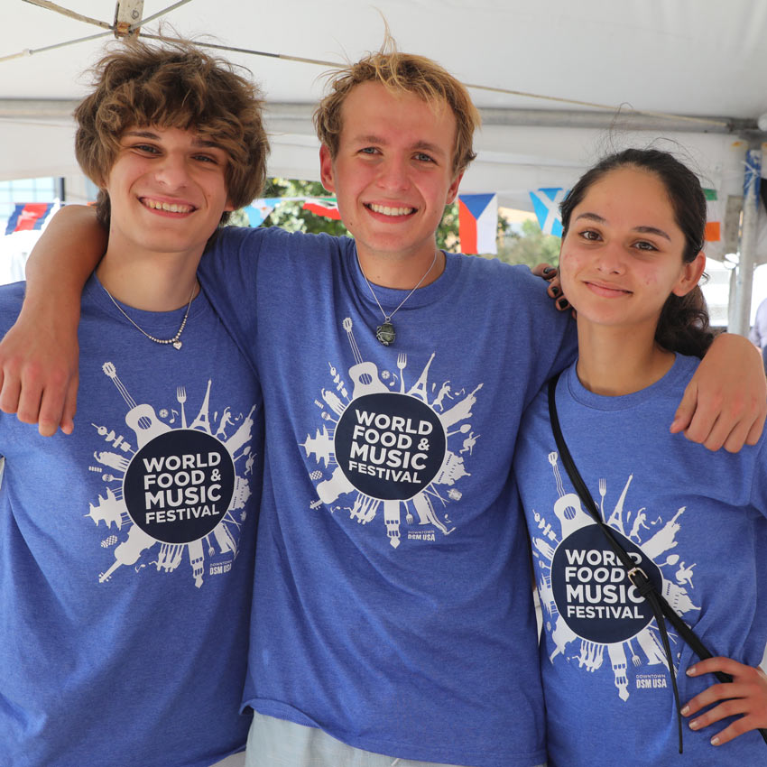 three volunteers with their arms around each other