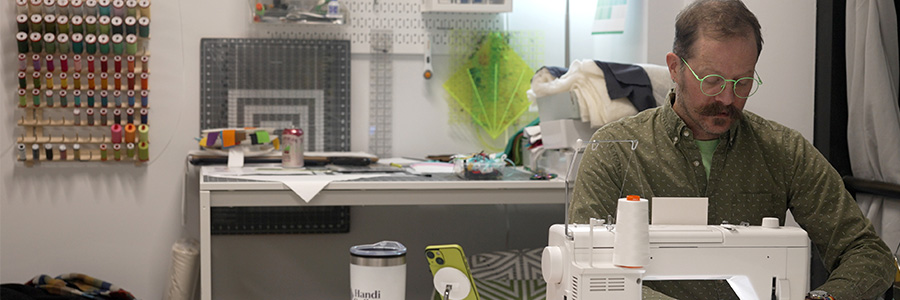 Mainframe Studios A man using a sewing machine