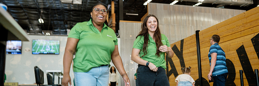 Smash Park Two girls throwing bags.