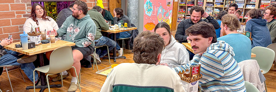 Rook Room A group of people at several tables playing games