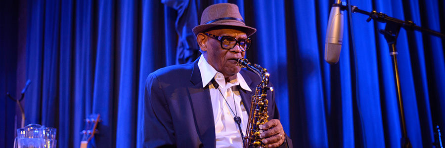 A man playing a saxophone on stage