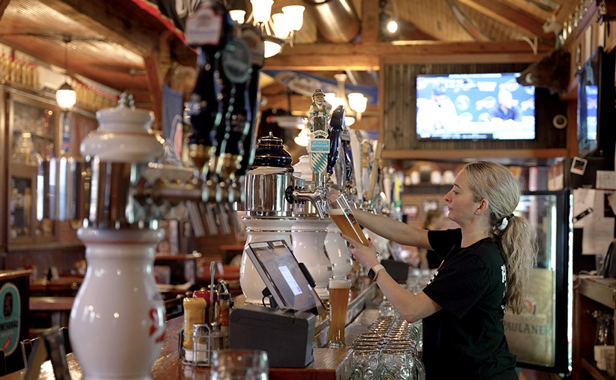A woman preparing a draft beer drink