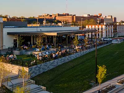 an outdoor patio full of people at tables and playing games