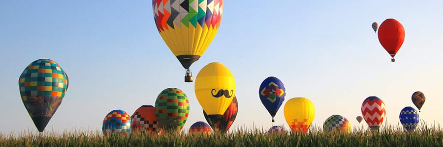 National Balloon Classic Several hot air balloons taking off from a field
