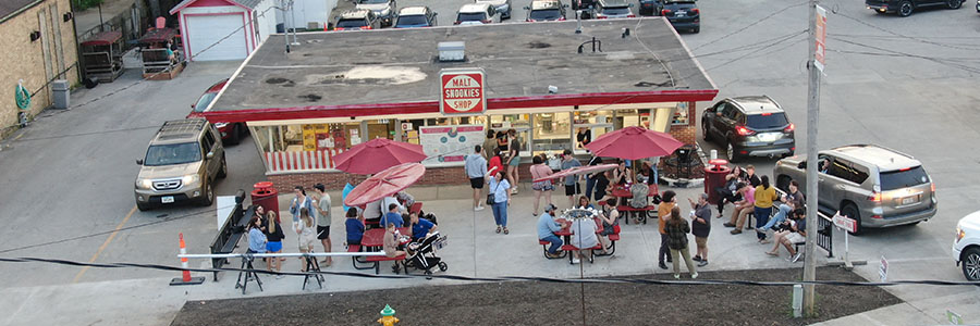 Snookie's Malt Shop A bird's eye view of Snookie's Malt Shop. There are around twenty people outside and a line of cars in the drive through.