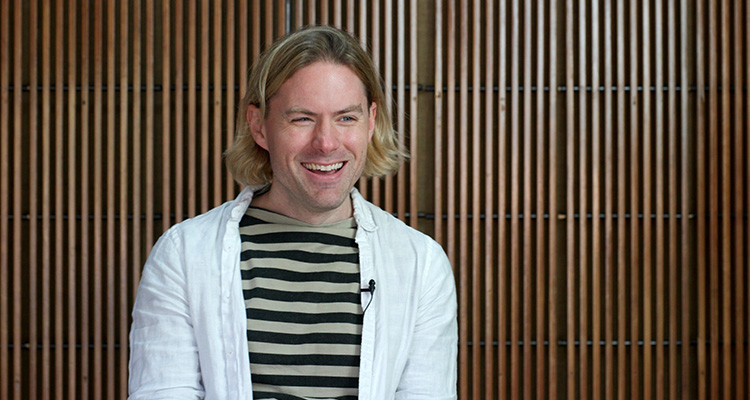 Bryan Vanderpool A man sitting in front of a wall smiling