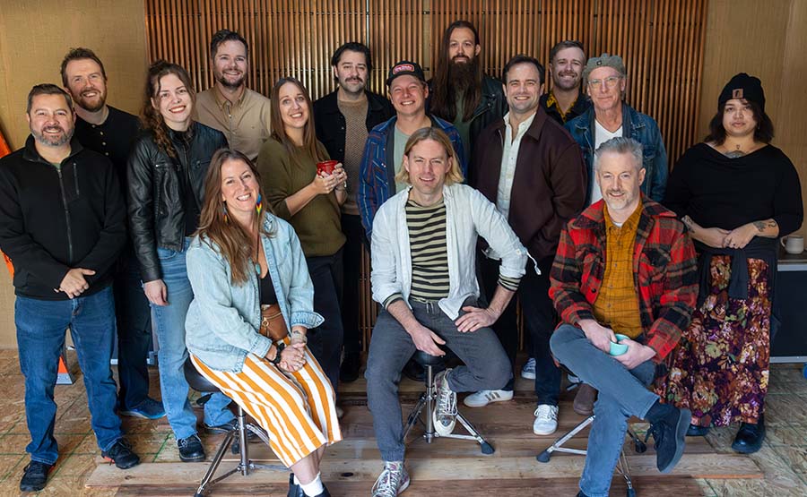 A group of musicians smiling together. 