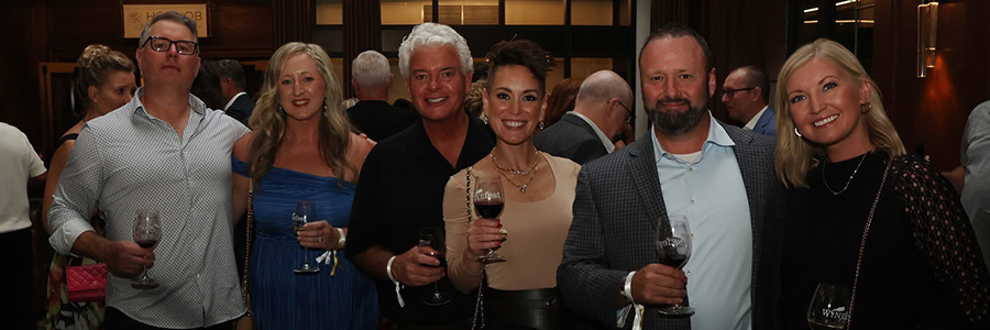 Jackie and her friends at WineFest A group of people holding glasses of wine and smiling