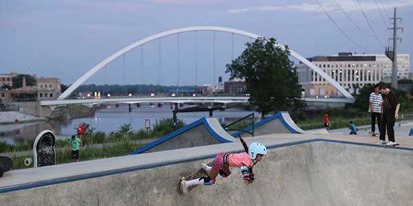 Lauridsen Skatepark a young girl skateboarding with a Des Moines bridge in the background