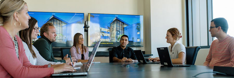 workplace meeting a group of professionals sitting around a table during a meeting.